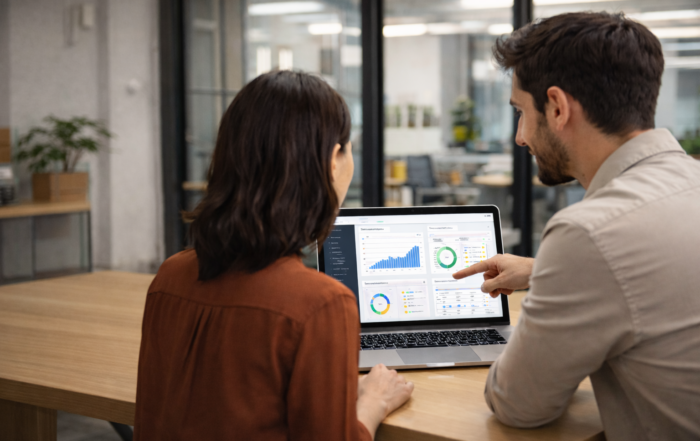 Two people looking at a laptop. Software Delivery Pressure can derail a project.