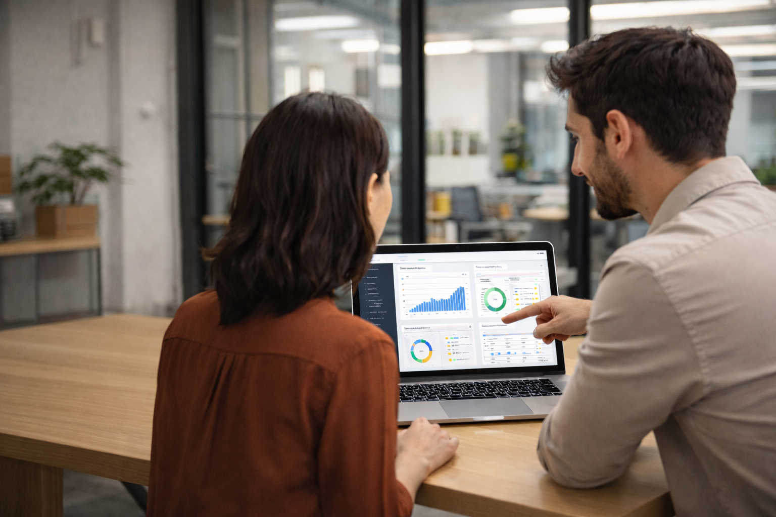 Two people looking at a laptop. Software Delivery Pressure can derail a project.